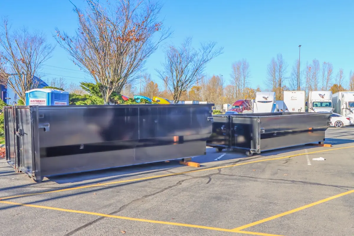 Professional dumpster rental service with roll-off container on residential driveway in Twentynine Palms